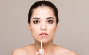 painting lips with lipstick